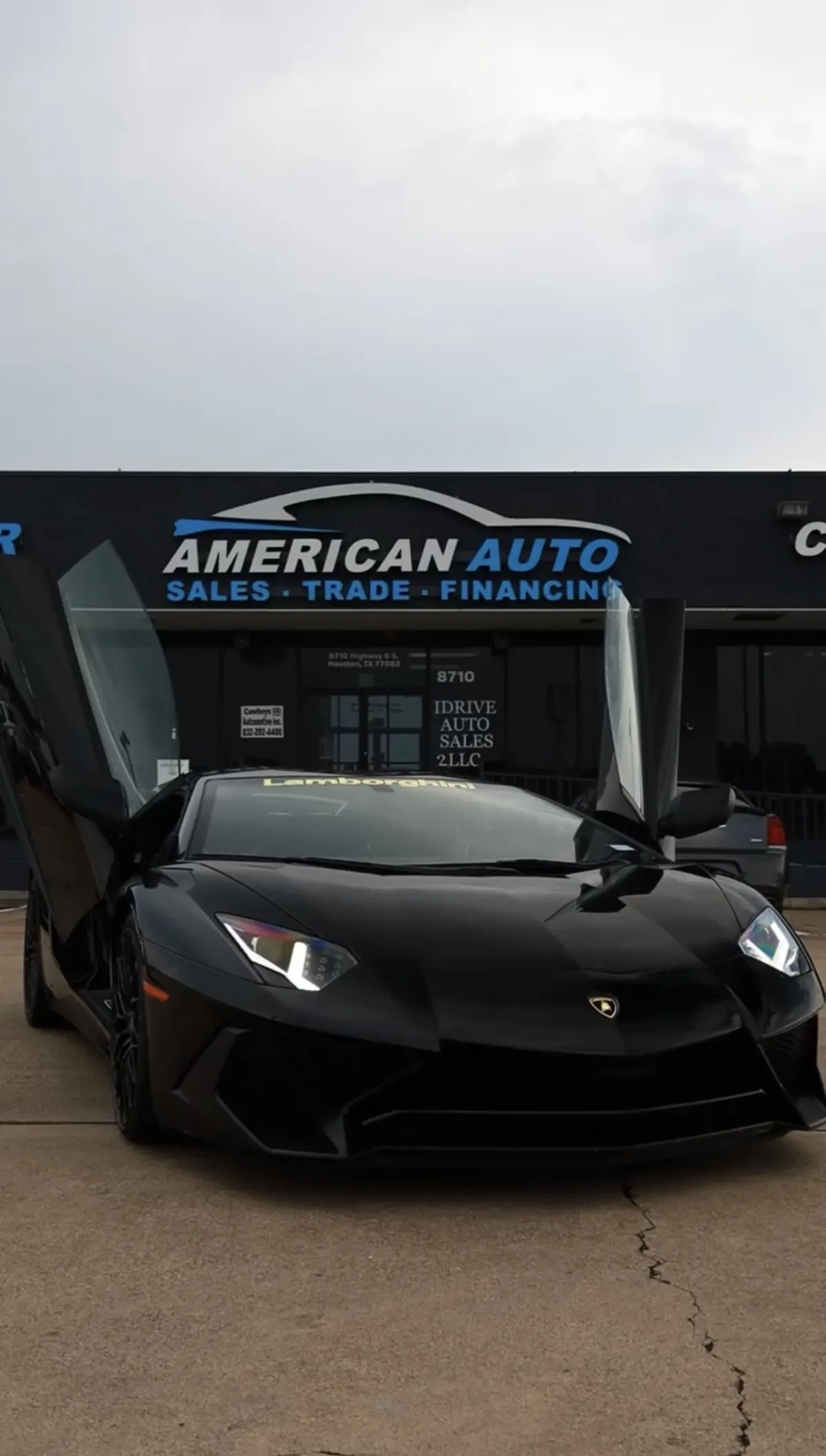 Black Lamborghini with open doors at American Auto near Sugar Land, TX